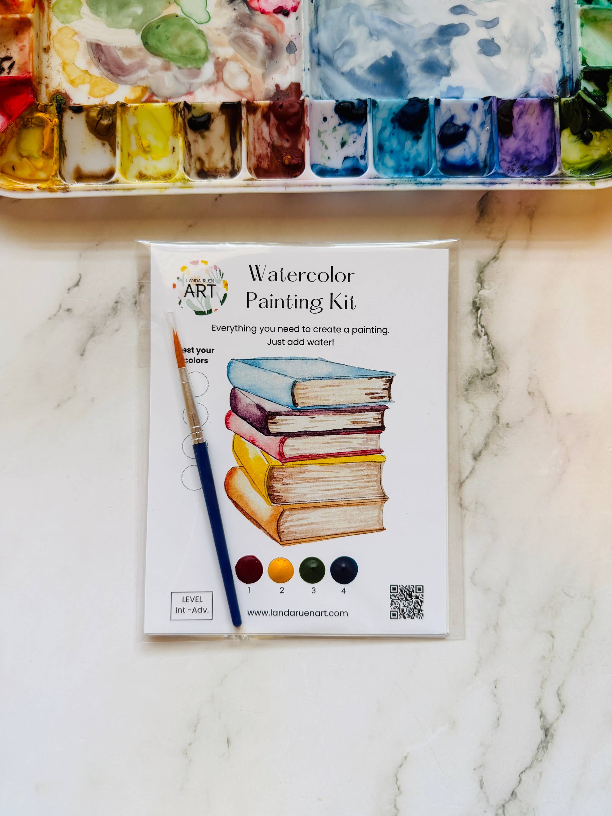 Watercolor painting kit on a marble surface