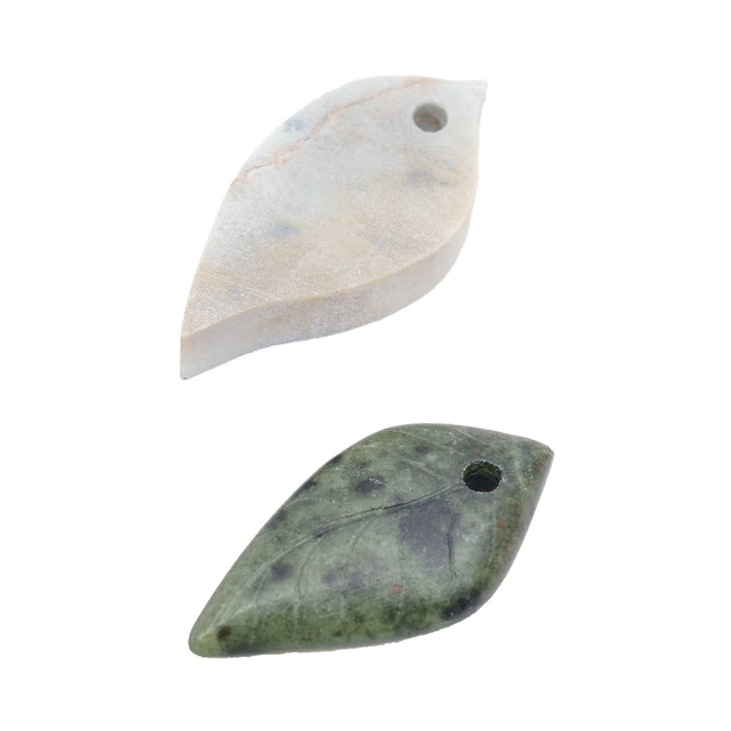 Two leaf shapes, one of the blank rough cut, and one of the finished project with smoothed edges and details carved in. 