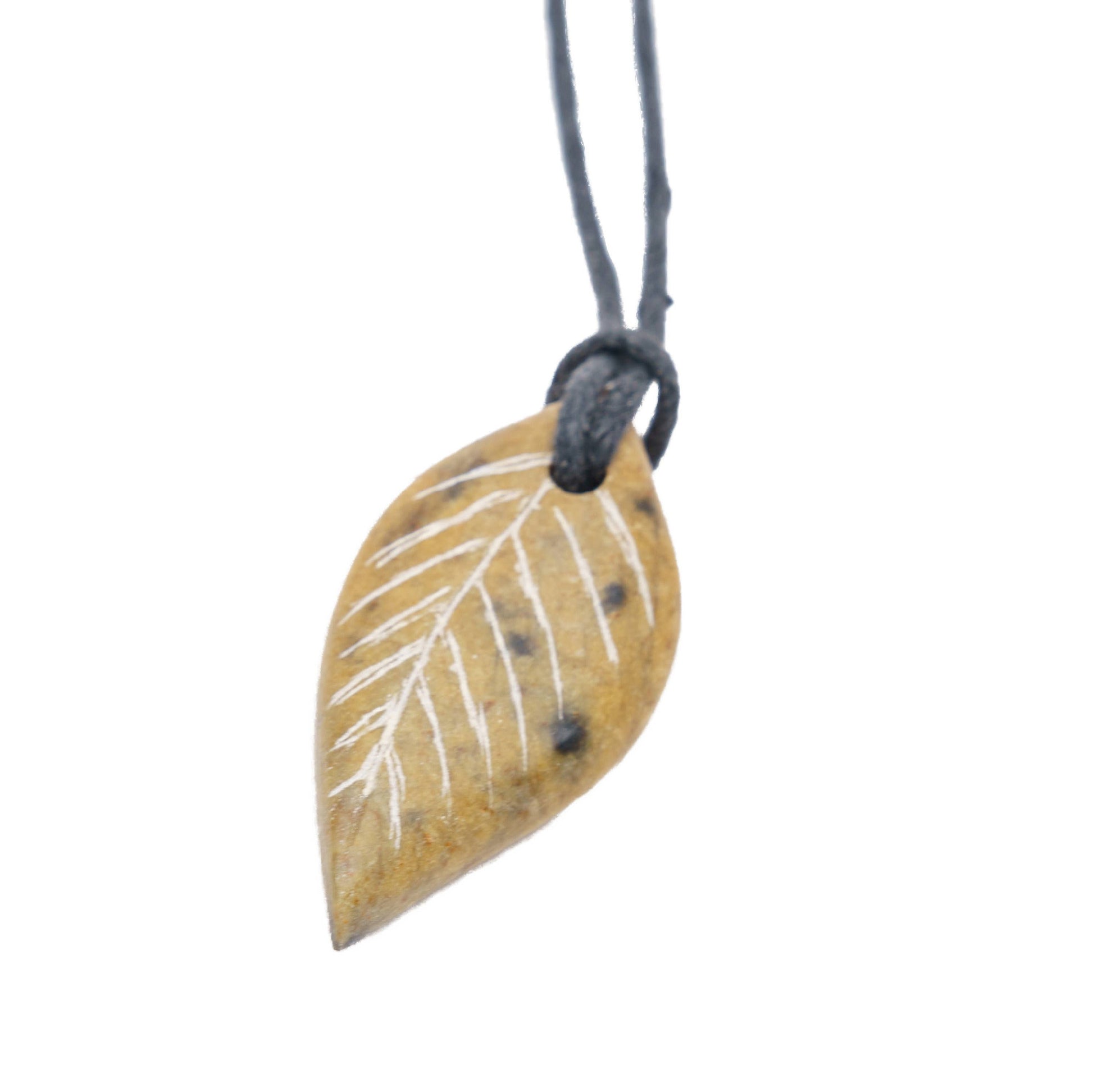 A close up view of a completed pendent, this one showing more golden brown tones. 