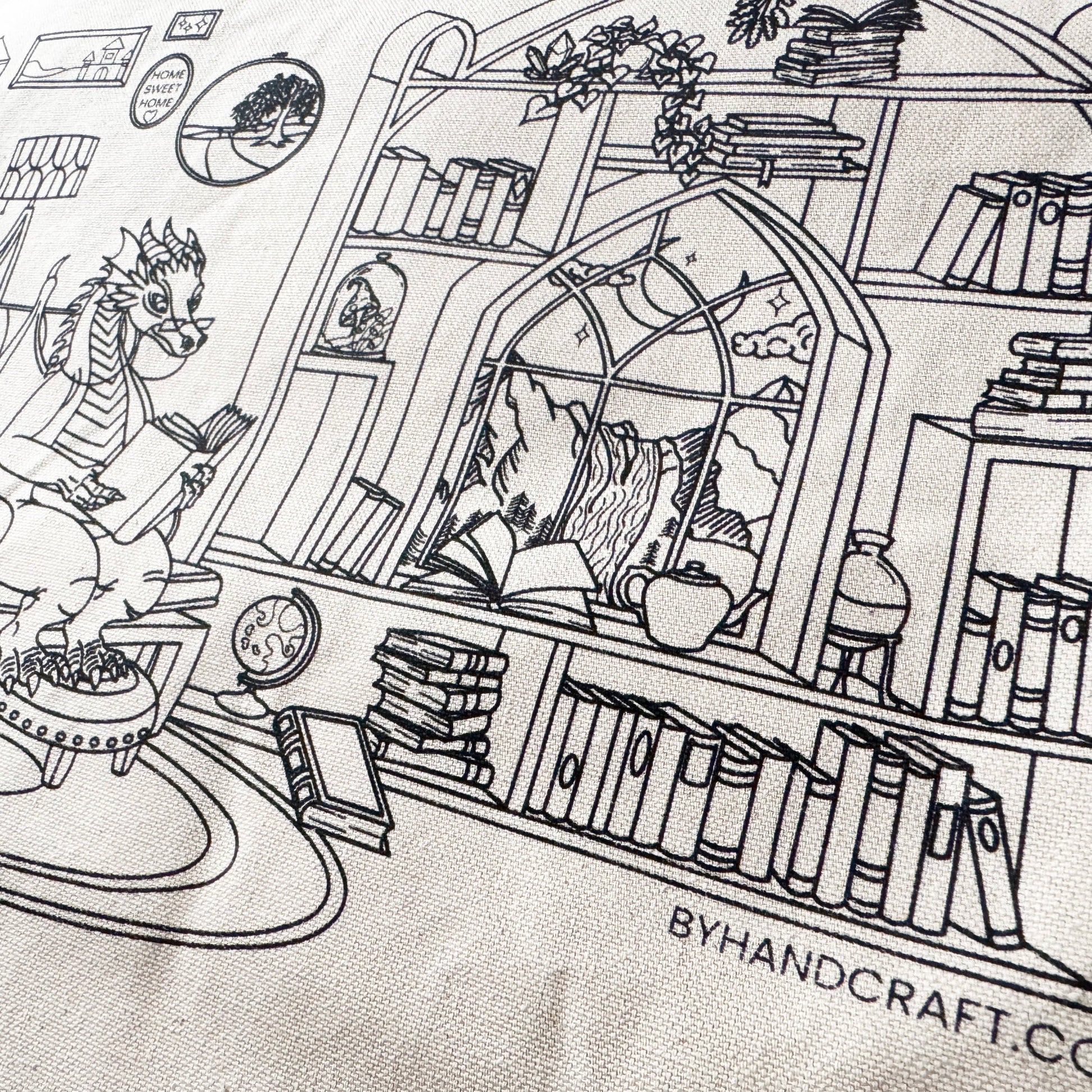 Black line illustration of a cozy room with many books and a dragon sitting in a chair reading.