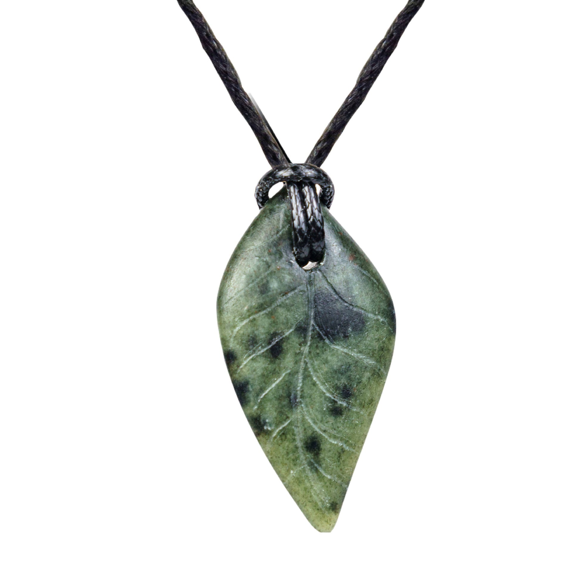 A close up view of a completed pendent, this one in green.