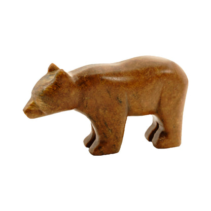 A finished brown bear soapstone figurine on a white background