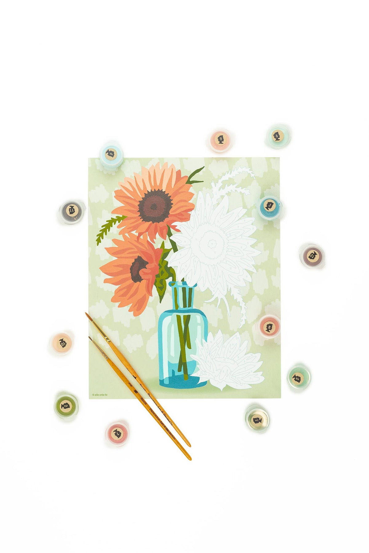 In progress paint by numbers painting of sunflowers in a vase, on a white background.