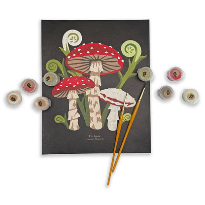 Paint by number kit with mushroom design and color swatches on a white background
