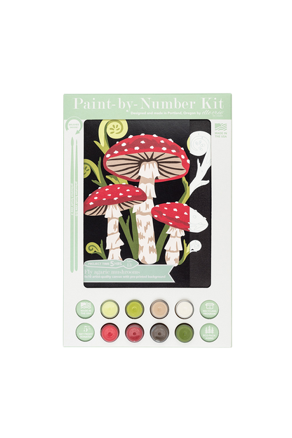 Paint by number kit with mushroom design and color swatches on a white background