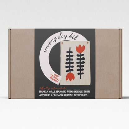 Cardboard box with a design on it featuring text and floral graphics, on a white background