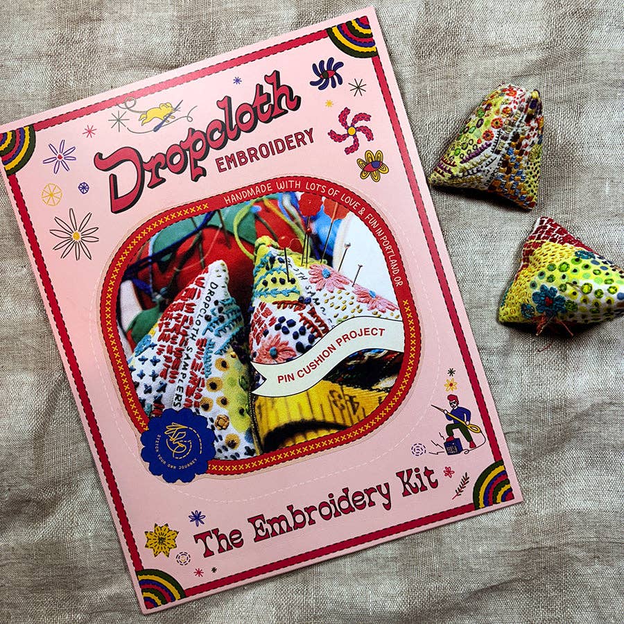Embroidery kit with colorful designs on a textured fabric background