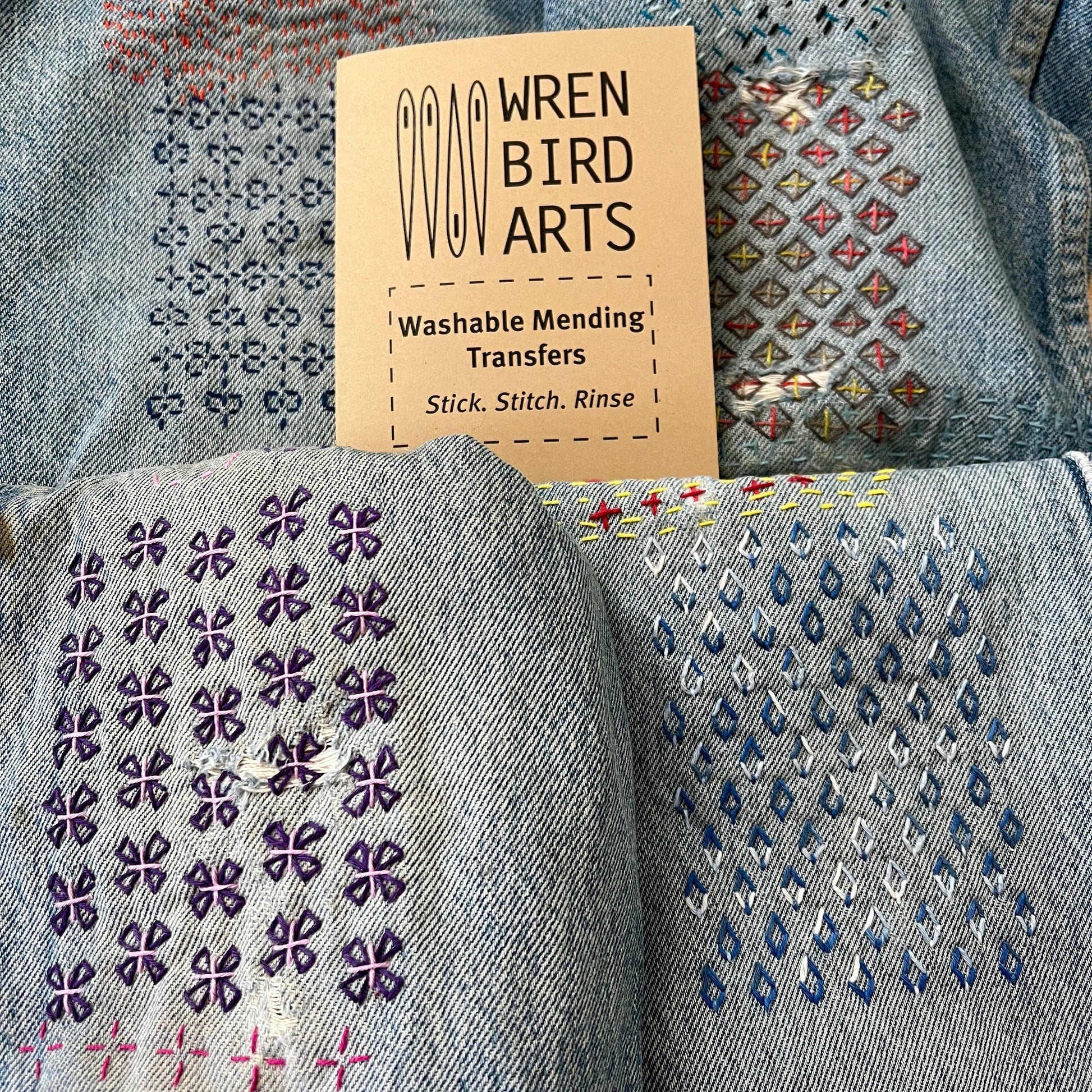 Finished examples of washable mending transfers on denim fabric with a label.