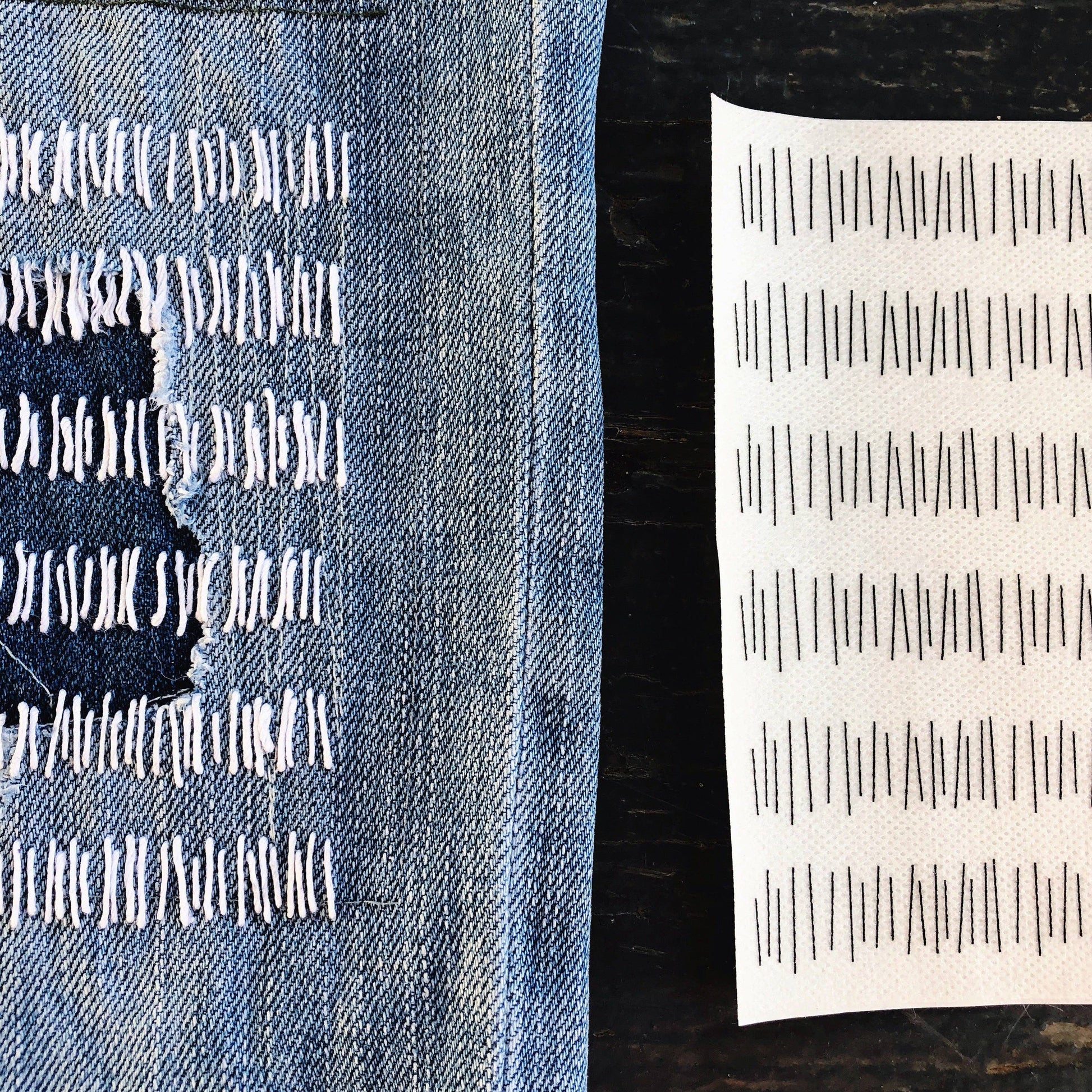 Sheet of mending transfers with a series of lines, next to a finished example on denim fabric