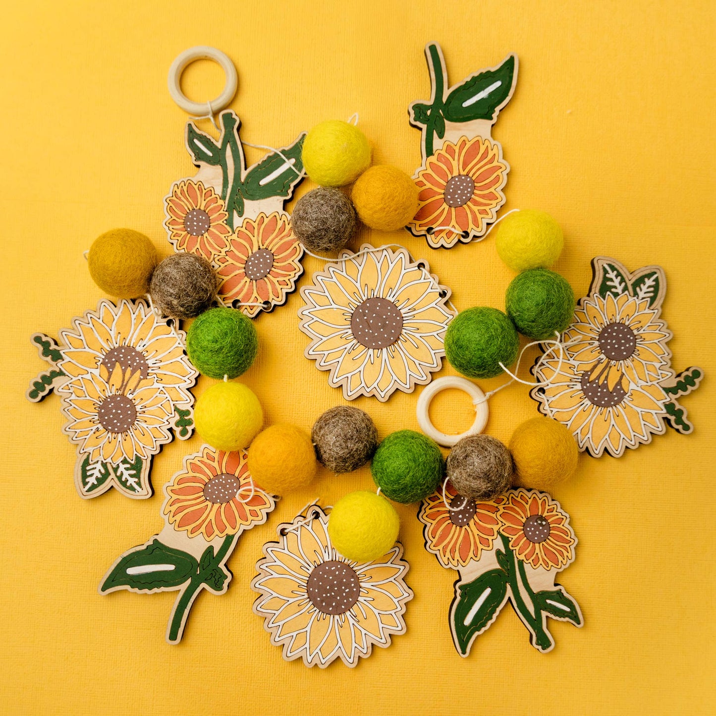 Garland with wooden sunflower shapes and felt balls