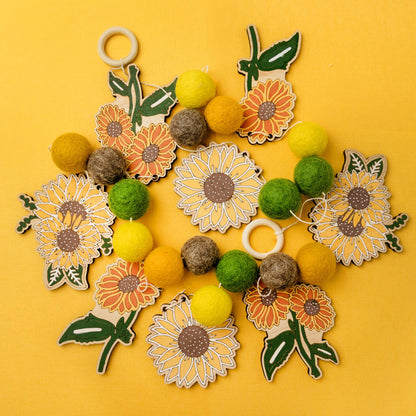 Garland with wooden sunflower shapes and felt balls