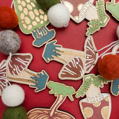 A garland of wooden mushroom-shapes with felt balls on a red background