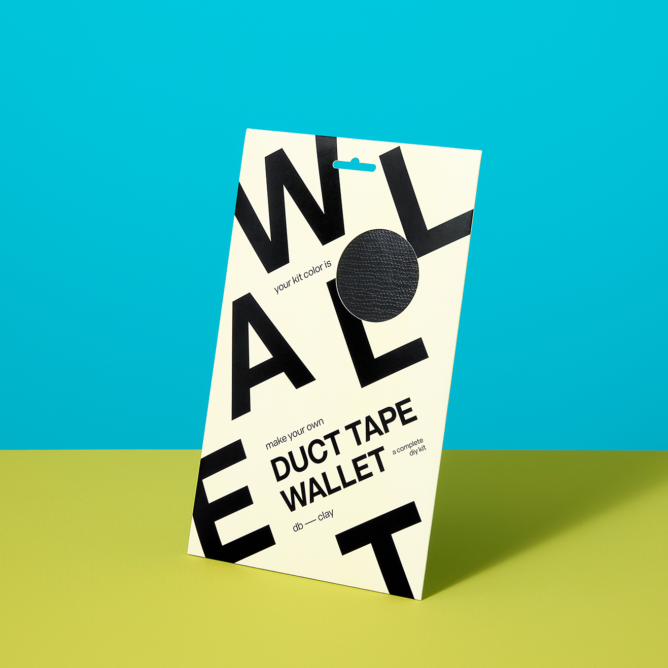 Black duct tape wallet kit in its packaging, against a blue and lime backgroundd