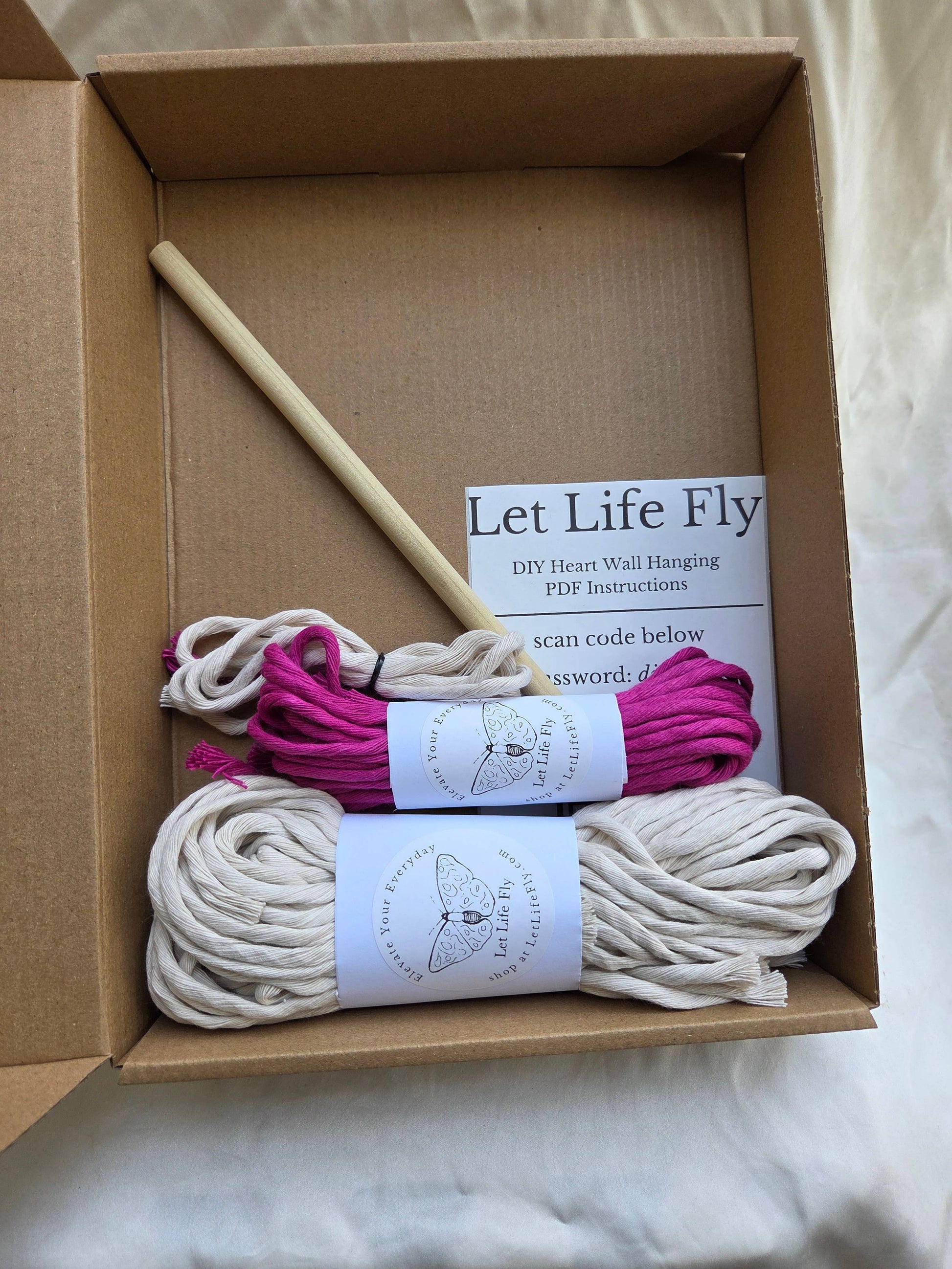 Box containing macrame cord, a wooden dowel, and a label with 'Let Life Fly' branding.
