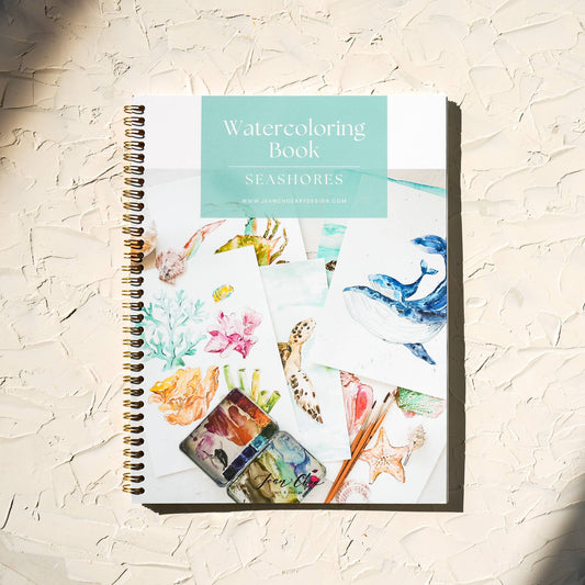 Watercoloring book titled 'Seashores' on a textured surface