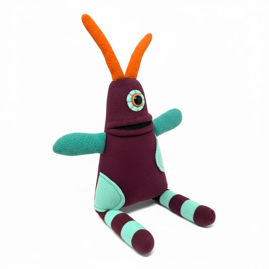 Colorful plush toy with orange antlers on a white background