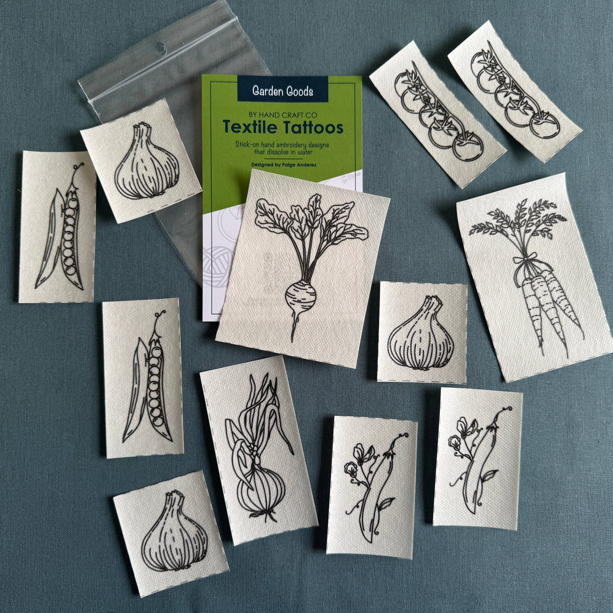 Textile tattoos with garden-themed designs on a blue gray background